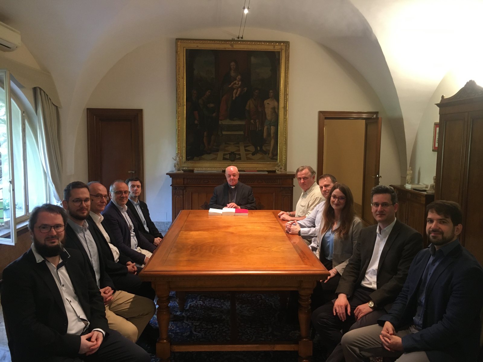 Members of the Research Group seated around a table, the Prefect of the Vatican Apostolic Archive in the centre